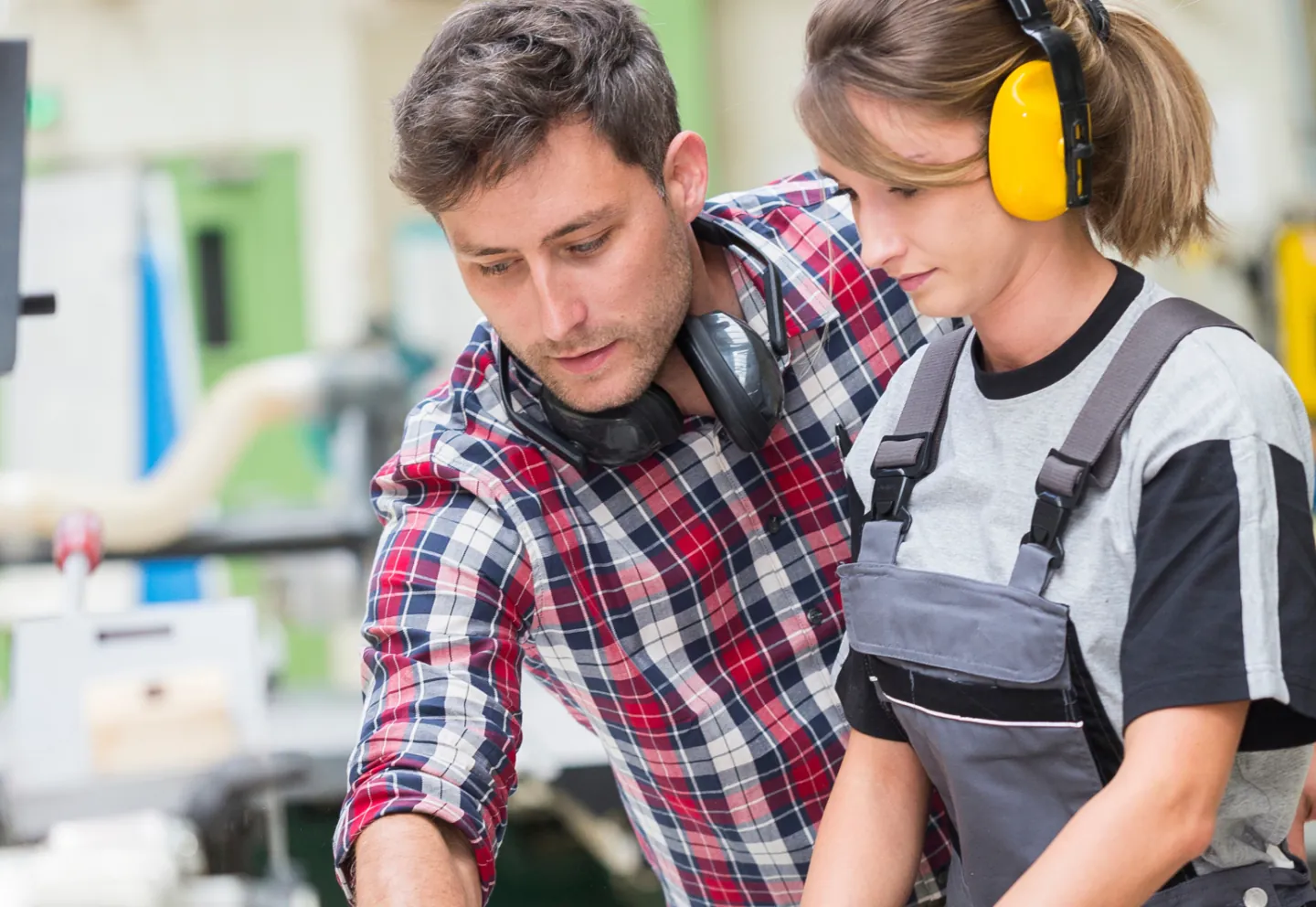 young apprentice with professionnal carpenter